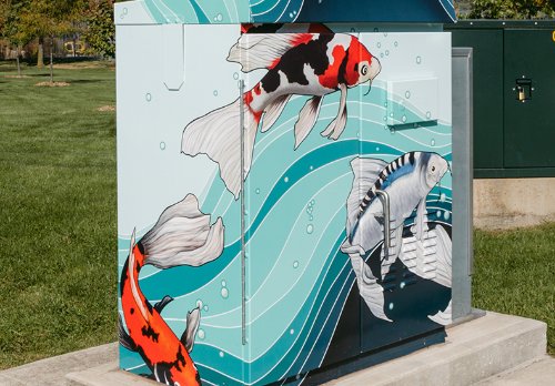 Traffic signal cabinet box wrap design titled "Lucky Koi", depicts koi fish against a flowing graphic background evoking water and waves.