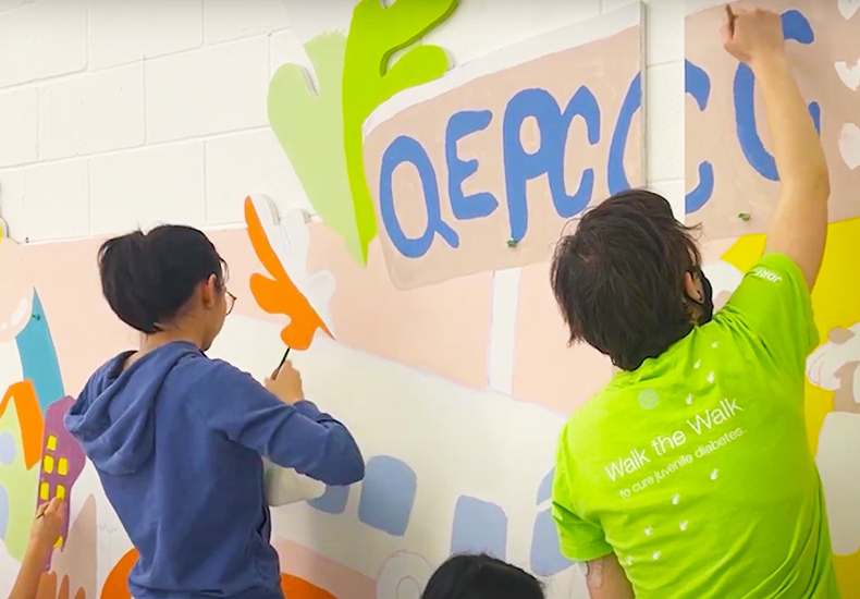 Youth painting the Youth Mural Project at Queen Elizabeth Park Community and Cultural Centre.