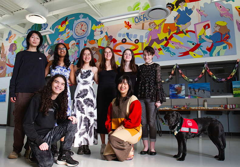 Group photo of the 2024 Oakville Youth Awards youth mural artists with the lead professional artist. Back row (all youth mural artists): Stella Gao, Ira Parasnis, Jeanne Lee, Olivia Pereira Cancela, Marianna Budnyak, Emma Cloutier, Echo the guide dog. Front row: Zachary Laflamme (youth mural artist), Yen Linh Thai (lead professional artist).