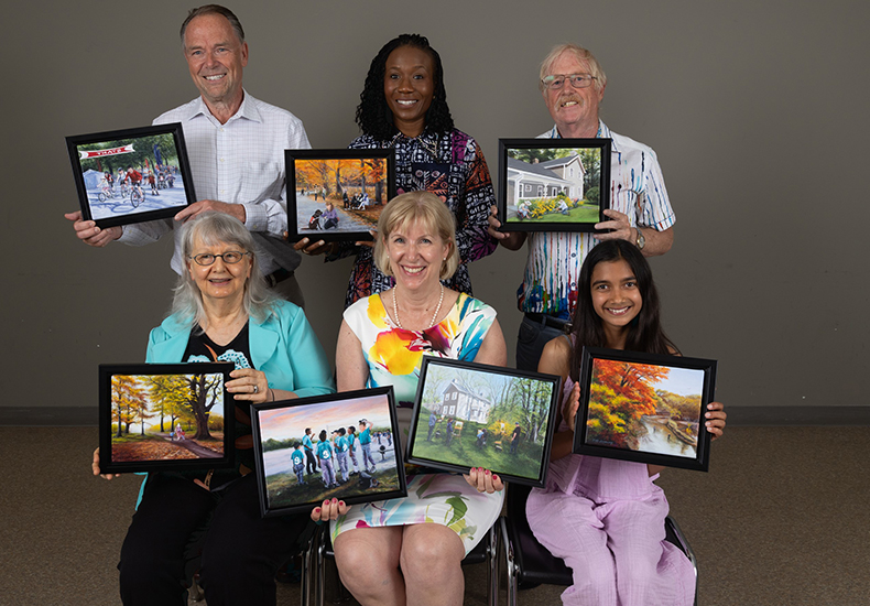 The 2024 Community Spirit Award recipients hold their awards. Top row, from left to right: Joe Berkmanns, Olamidotun Votu-Obada and Charles Yaeck. Bottom row, from left to right: Ruth Sheridan, Cathy Lorraway and Gweneth Arumainayagam. Missing from photo: Rachel Williams and Fatima Sultan.