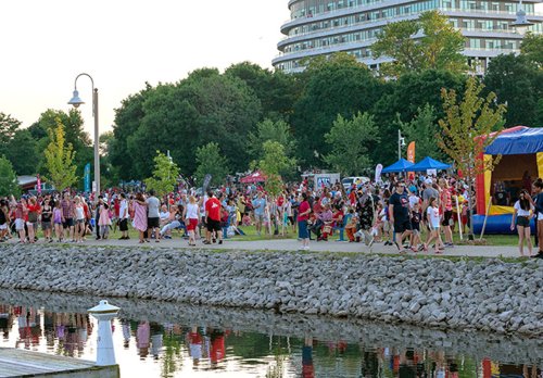 Residents and visitors walk along the lakeshore in Bronte celebrating Canada Day.