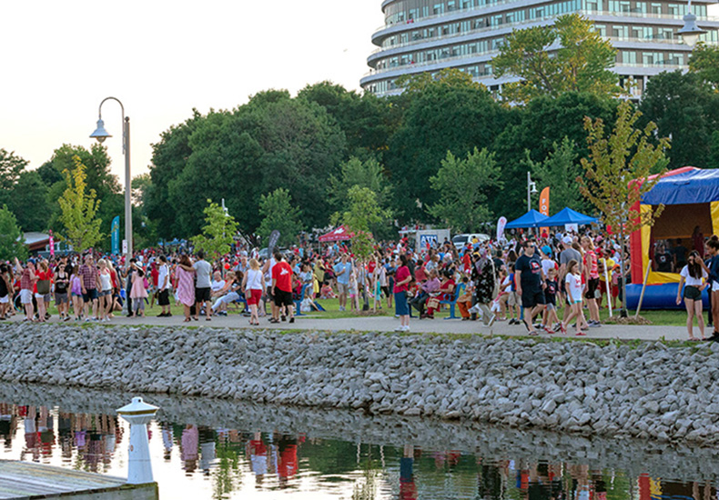 Residents and visitors walk along the lakeshore in Bronte celebrating Canada Day.