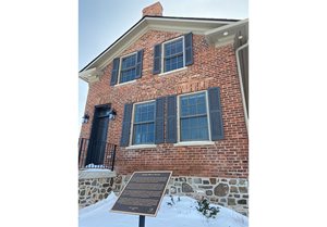 The brick home at 3020 Post Road is a simple vernacular version of the Classic Revival style.