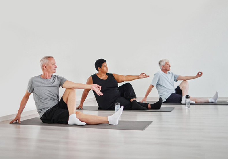 Three adults practicing yoga.